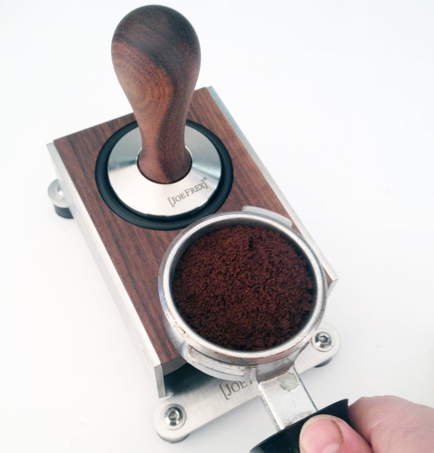 Tamping station walnut with tamper and portafilter and coffee , ready to be pressed
