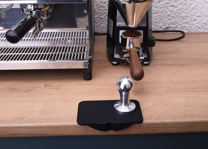 tamping mat black both sided in front of espresso machine