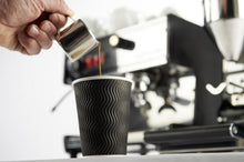 Load image into Gallery viewer, Milk Jug  3oz/90ml for latte art and barista. next to a espresso machine and a knockbox